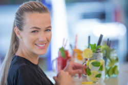 attract young bar owner preparing drinks as part of good customer service