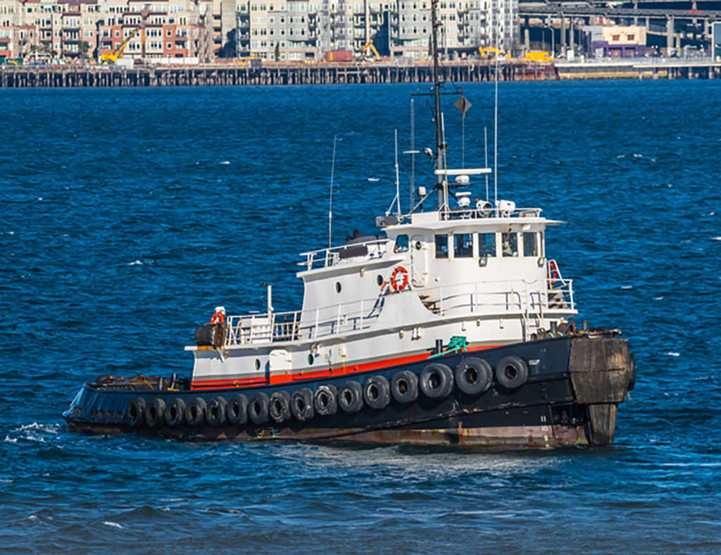 Old tug in Seattle harbot with blue water and a few whitecaps.